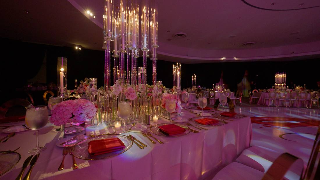 Reception table with crystal candle towers and soft pink floral accents