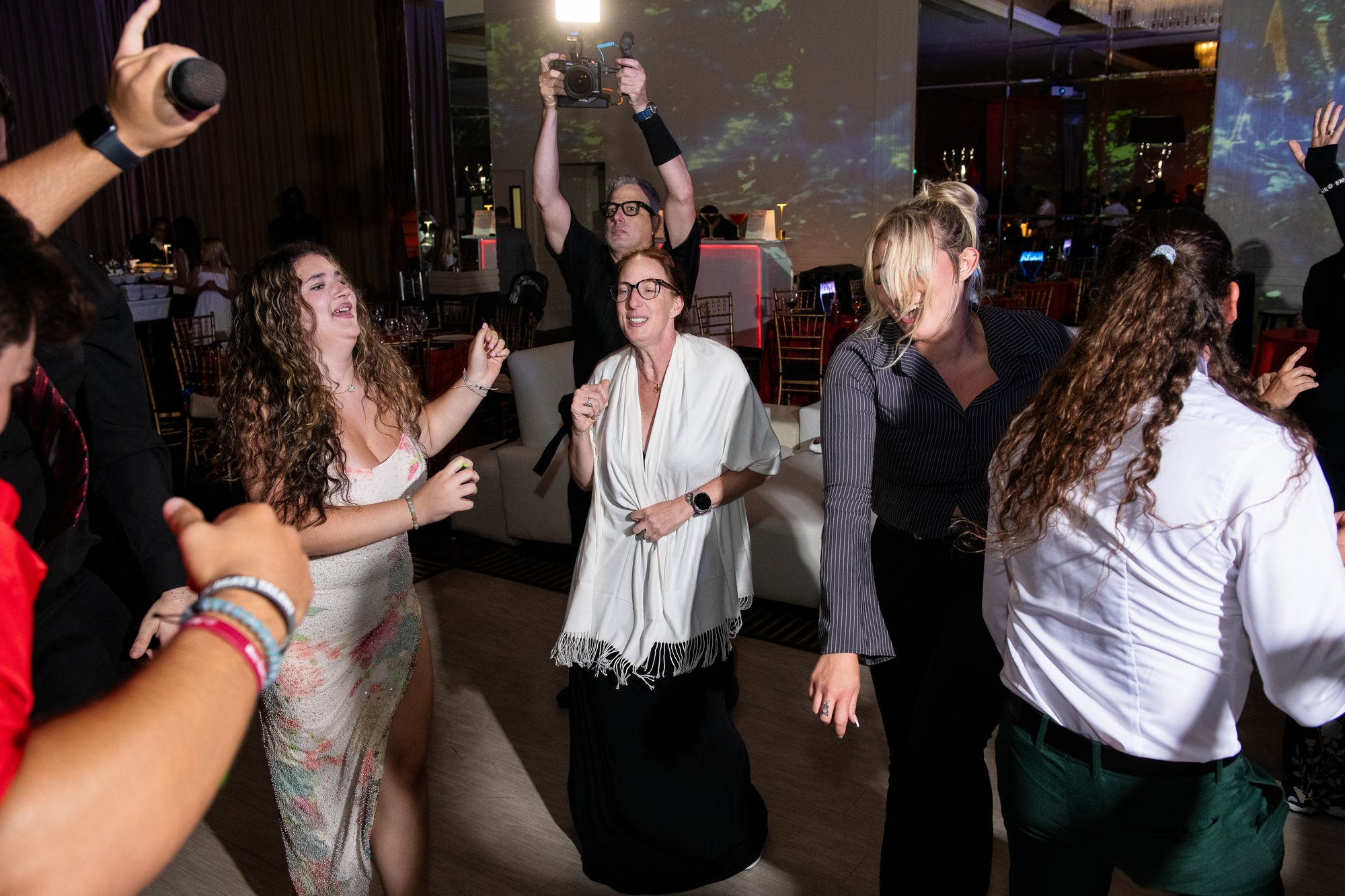 Spotlight Media videographer filming guests on the dance floor