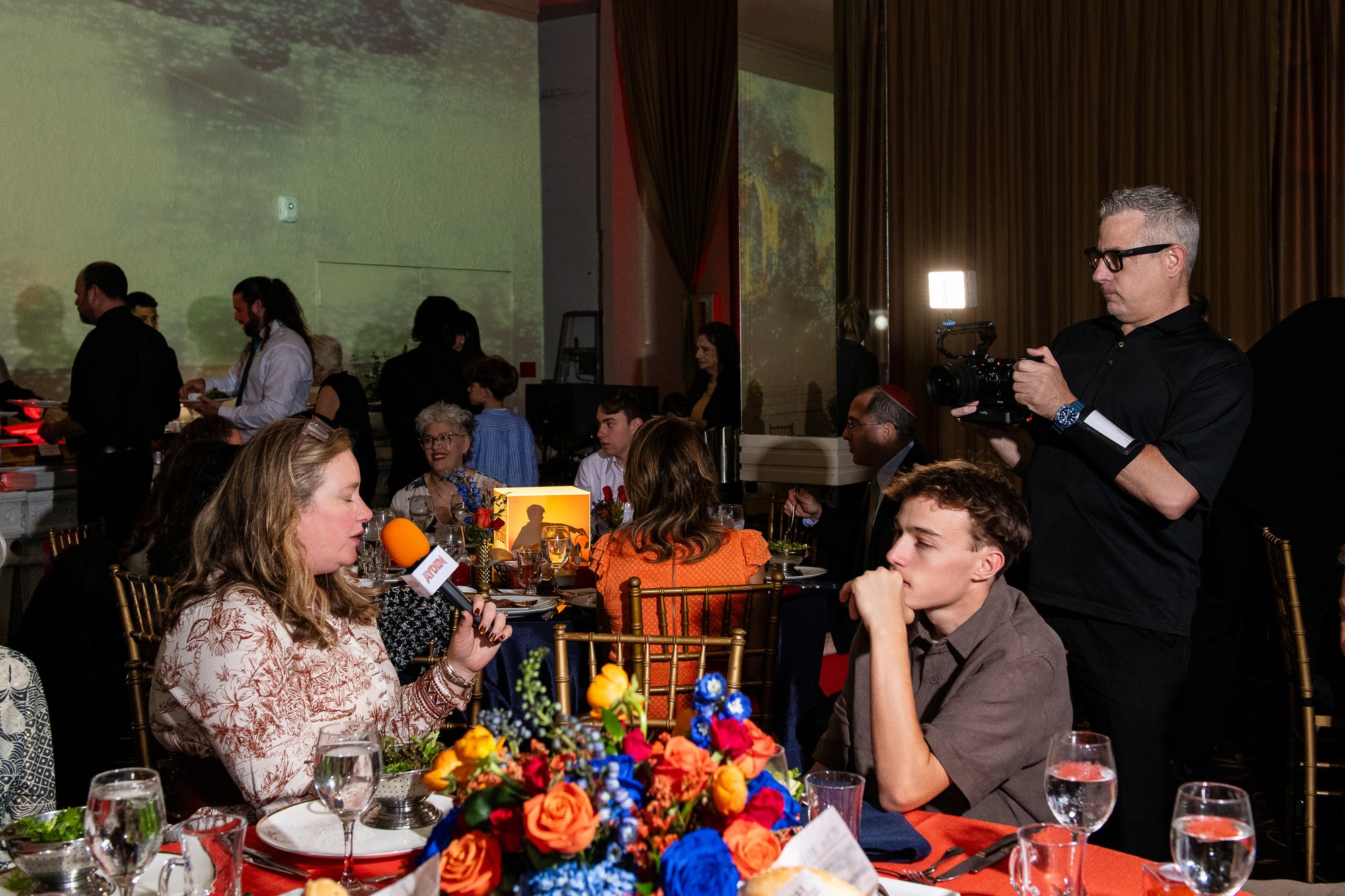 Filming a family moment beside the head table