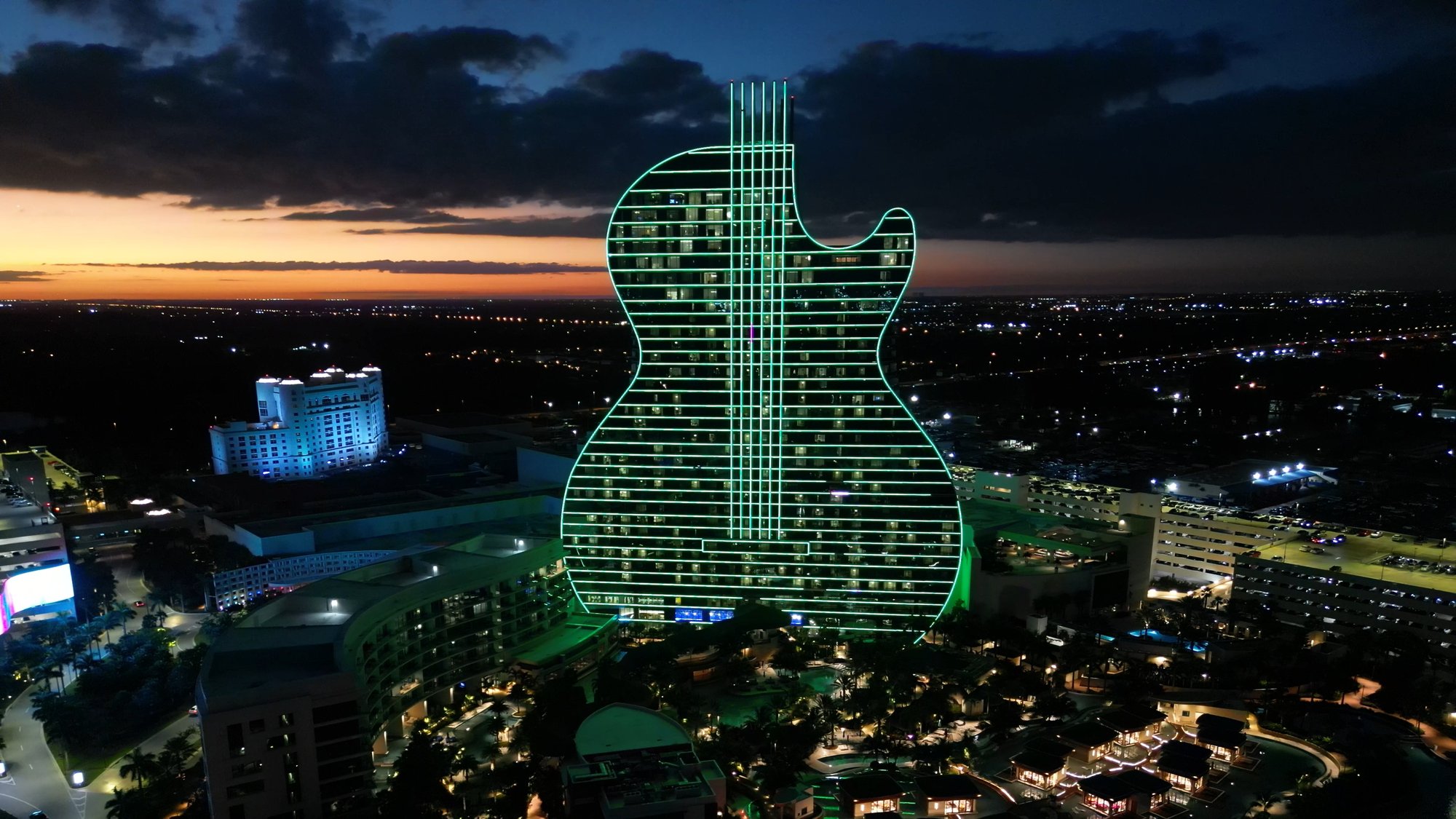 Aerial view of the Seminole Hard Rock guitar hotel lit up at dusk